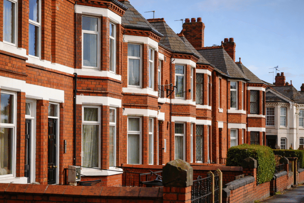 Row of older brick houses in Sutton Coldfield with solid walls that lose heat and feel cold in winter.
