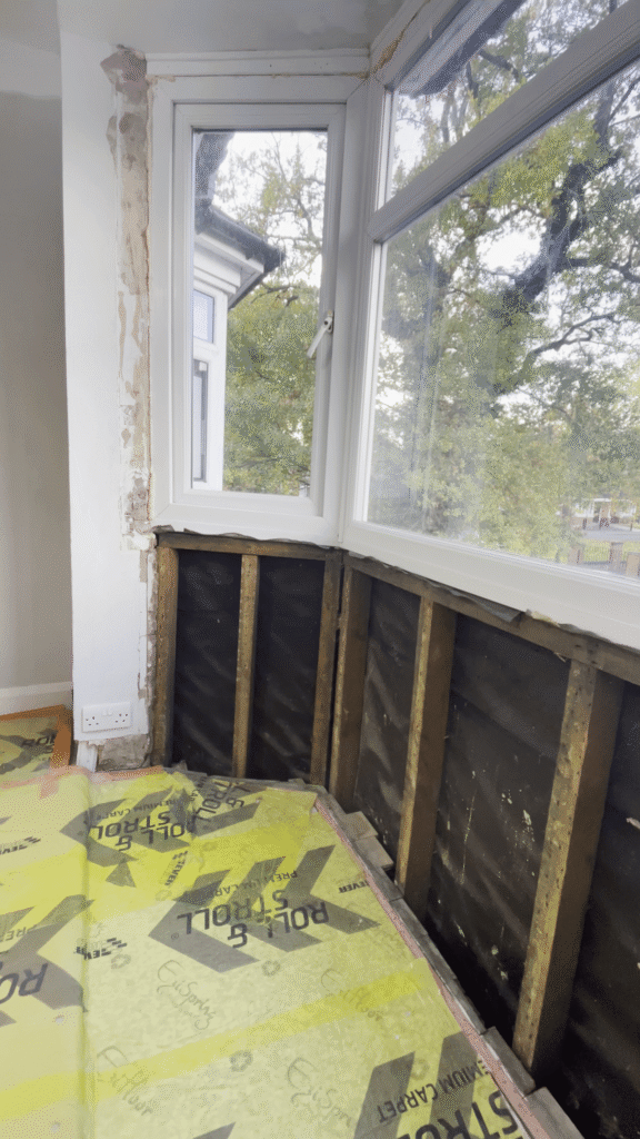 Uninsulated bay window with exposed internal wall in a Sutton Coldfield home.