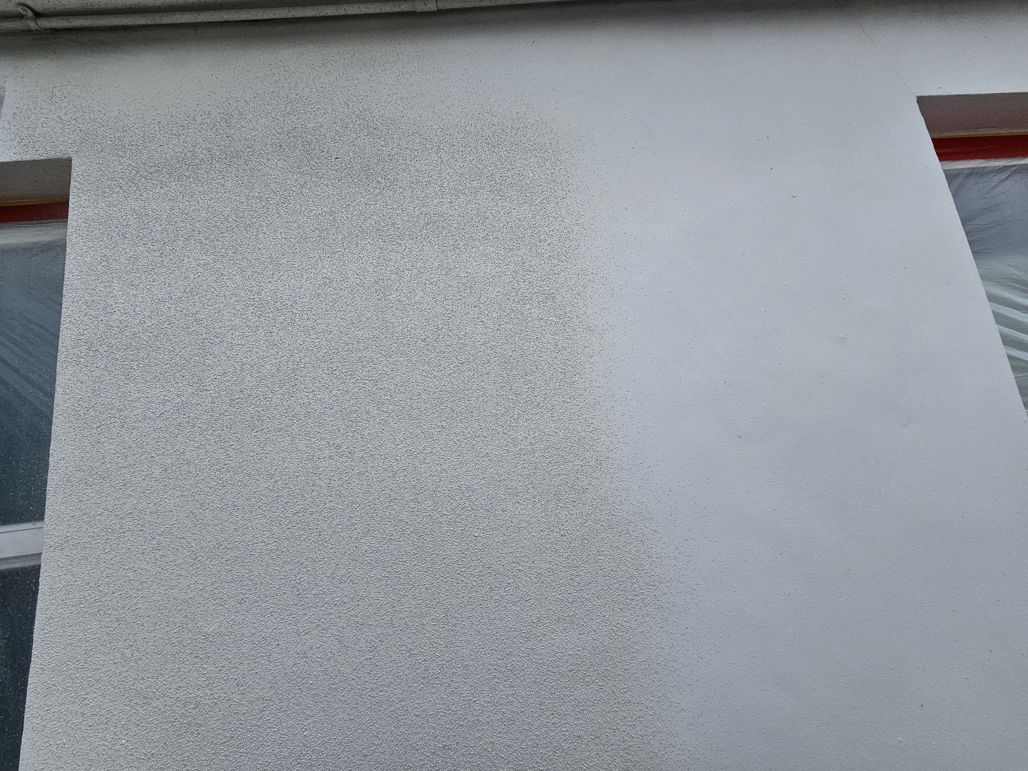 Process of spraying cork coating onto exterior wall during installation