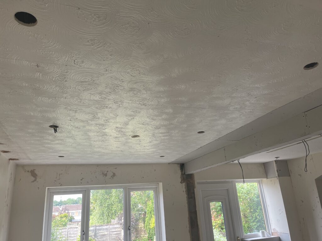 Artex ceiling before plastering showing textured surface
